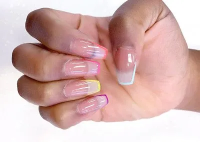Sheer nails with neon rainbow French tips