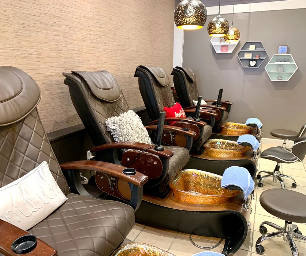 The pedicure lounge at CoCo Nails with gold-bowl spa chairs